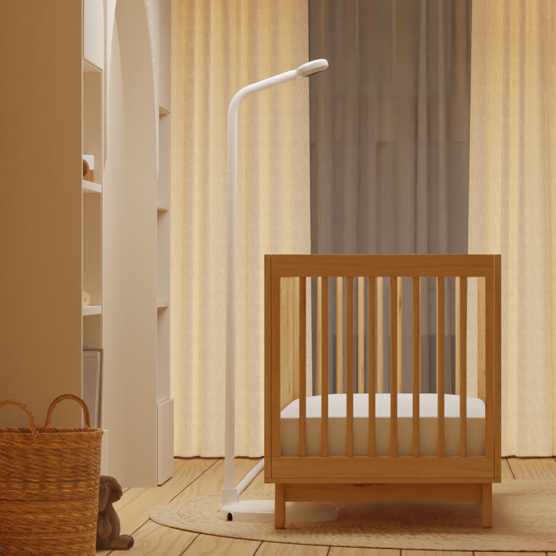 side view of nanit pro camera + floor stand in front of low crib where floor stand fits #mount_floor stand